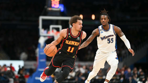 Atlanta Hawks guard Trae Young dribbles past Washington Wizards guard Delon Wright.